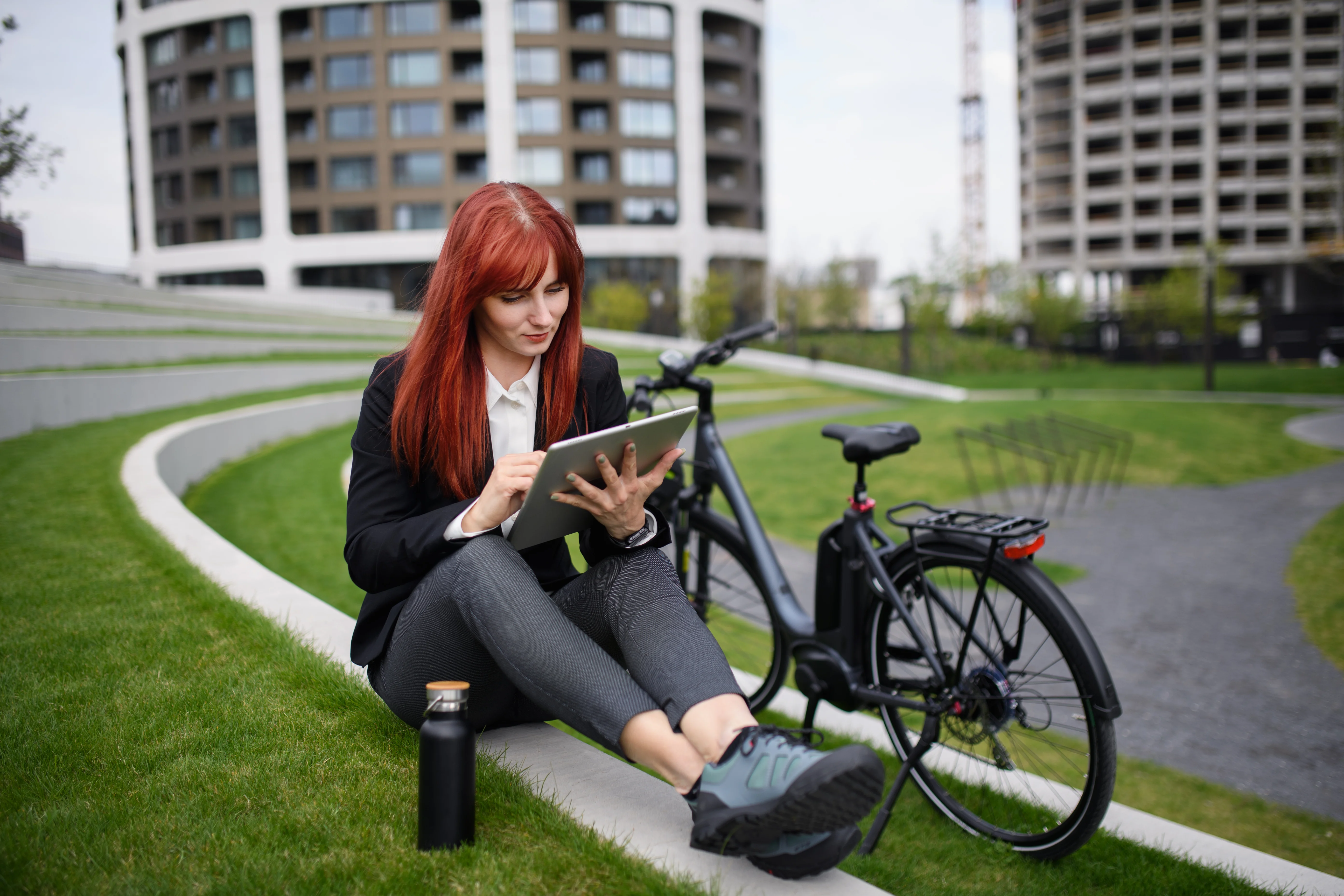 businesswoman-with-bike-sitting-on-stairs-and-usin-2022-11-19-01-06-11-utc